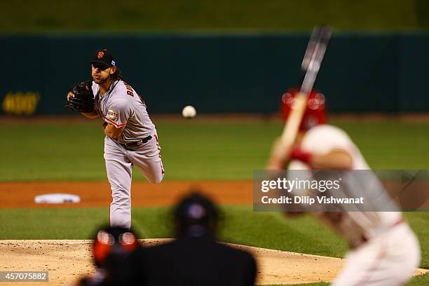 Madison Bumgarner of the San Francisco Giants pitches in the first inning against the St. Louis Cardinals during Game One of the National League...