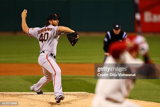 Madison Bumgarner of the San Francisco Giants pitches in the first inning against the St. Louis Cardinals during Game One of the National League...