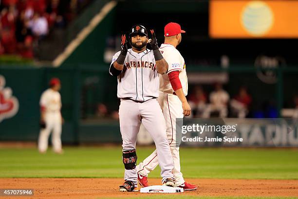 Pablo Sandoval of the San Francisco Giants celebrates on second base after hitting a double in the second inning against the St. Louis Cardinals...