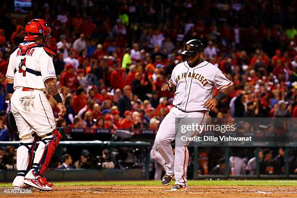 Pablo Sandoval of the San Francisco Giants runs home to score on an RBI single by Travis Ishikawa in the second inning against the St. Louis...