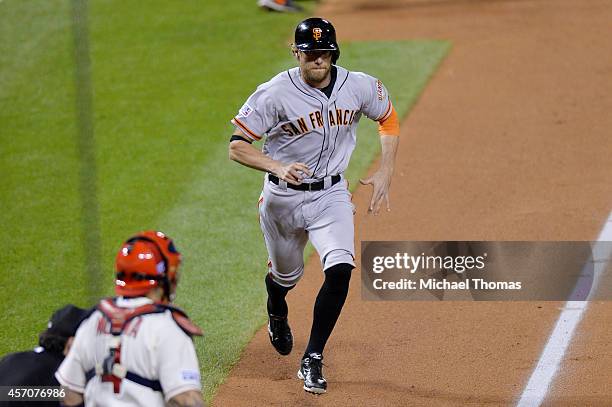 Hunter Pence of the San Francisco Giants runs home to score on an error by Matt Carpenter of the St. Louis Cardinals in the second inning during Game...