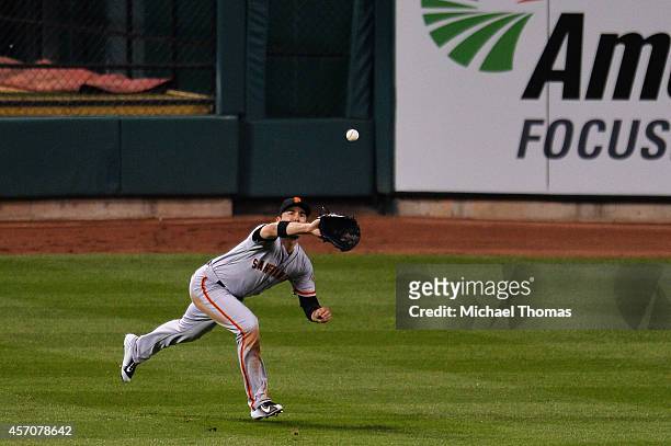 Travis Ishikawa of the San Francisco Giants fields a ball hit by Yadier Molina of the St. Louis Cardinals for an out in the fourth inning during Game...