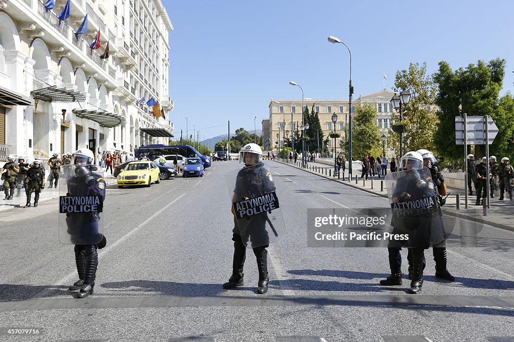Greek Police in riot gear are on stand by, blocking off side...