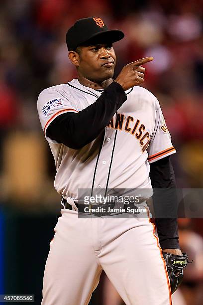 Santiago Casilla of the San Francisco Giants reacts in the ninth inning against the St. Louis Cardinals during Game One of the National League...