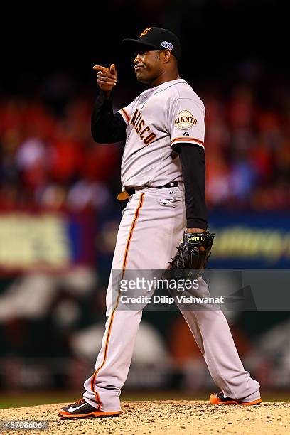 Santiago Casilla of the San Francisco Giants reacts in the ninth inning against the St. Louis Cardinals during Game One of the National League...