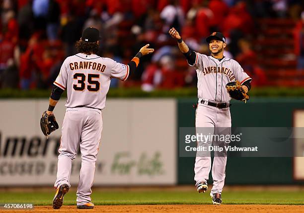 Brandon Crawford and Gregor Blanco of the San Francisco Giants celebrate after their 3 to 0 win over the St. Louis Cardinals during Game One of the...