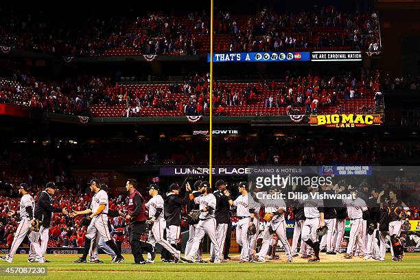 The San Francisco Giants celebrate their 3 to 0 win over the St. Louis Cardinals in Game One of the National League Championship Series at Busch...