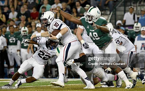 Connecticut quarterback Chandler Whitmer feels the pressure from Tulane defensive end Royce LaFrance and is sacked during the first quarter at Yulman...