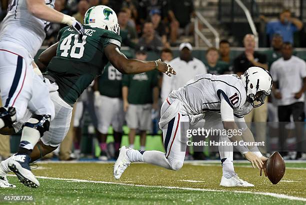 Connecticut quarterback Chandler Whitmer chases down his own fumble late in the fourth quarter as Tulane's Royce LaFrance pursues at Yulman Stadium...