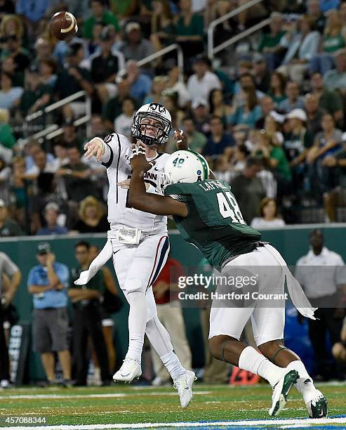 Connecticut quarterback Chandler Whitmer gets rid of the ball under pressure from Tulane's Royce LaFrance during the first half at Yulman Stadium in...