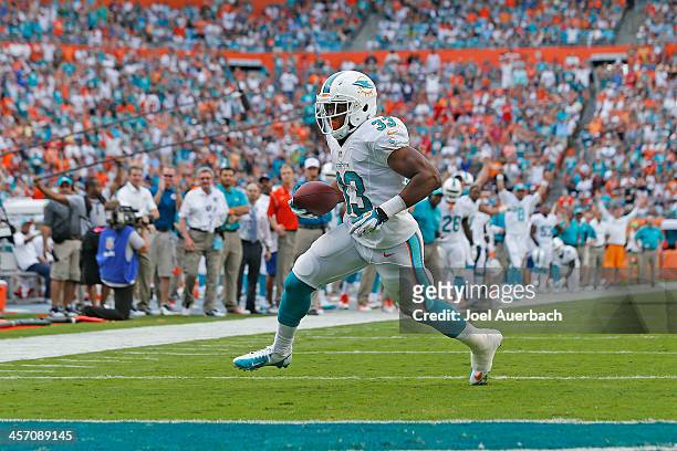Daniel Thomas of the Miami Dolphins runs for a touchdown after catching a two yard pass from Ryan Tannehill in the fourth quarter against the New...