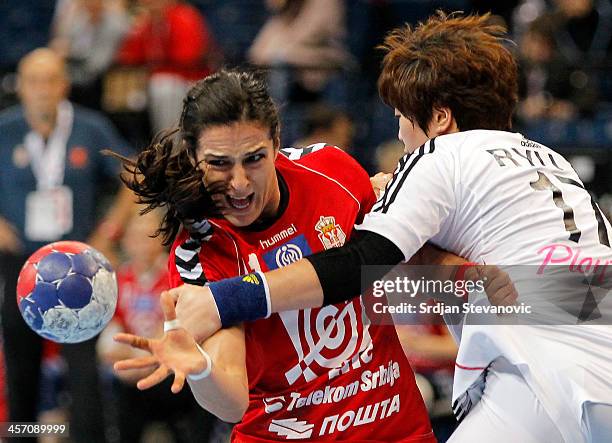 Sanja Damnjanovic of Serbia competes for the ball with Eun Hee Ryu of South Korea during the 2013 World Women's Handball Championship 2013 match...