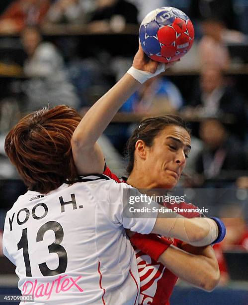 Sanja Damnjanovic of Serbia is challenged by Hyunji Yoo of South Korea during the 2013 World Women's Handball Championship 2013 match between South...