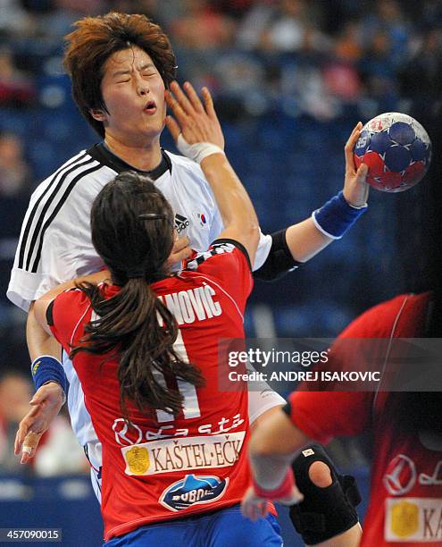 South Korea's Eun Hee Ryu vies with Serbia's Sanja Damnjanovic during the 2013 Women's Handball World Championship round of sixteen match between...