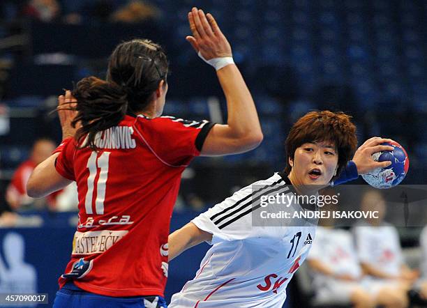 South Korea's Eun Hee Ryu vies with Serbia's Sanja Damnjanovic during the 2013 Women's Handball World Championship round of sixteen match between...
