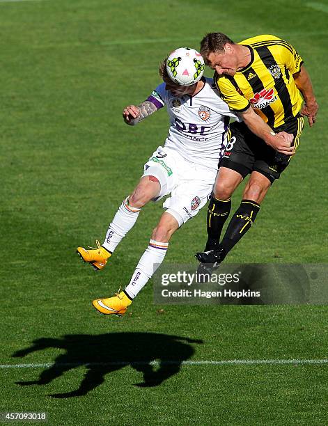 Andy Keogh of the Glory and Ben Sigmund of the Phoenix compete for a header during the round one A-League match between Wellington Phoenix and Perth...