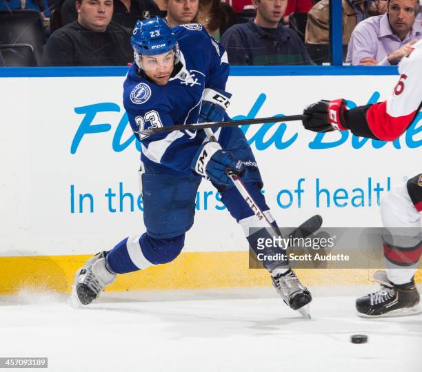Brown of the Tampa Bay Lightning passes the puck against the Ottawa Senators at the Tampa Bay Times Forum on December 5, 2013 in Tampa, Florida.