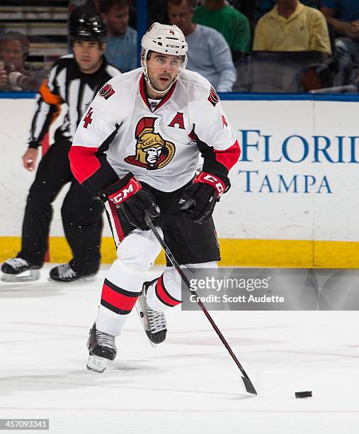 Chris Phillips of the Ottawa Senators carries the puck against the Tampa Bay Lightning at the Tampa Bay Times Forum on December 5, 2013 in Tampa,...