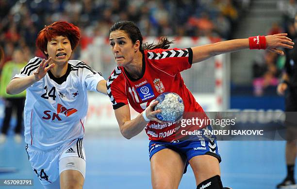 Serbia's Sanja Damnjanovic vies with South Korea's Han Na Gwon during the 2013 Women's Handball World Championship round of sixteen match between...