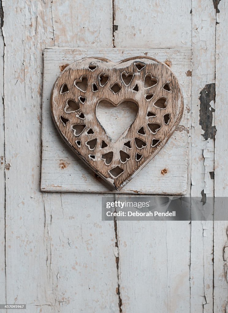 Wooden heart on painted wooden background