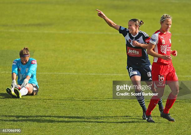 Amy Jackson of Melbourne celebrates after beating Adelaide goalkeeper Melissa Barbieri to score a goal as Katie Holtham of Adelaide looks on during...