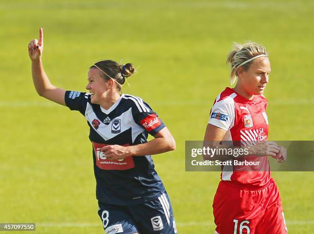 Amy Jackson of Melbourne celebrates after scoring a goal as Katie Holtham of Adelaide looks on during the round five W-League match between Melbourne...