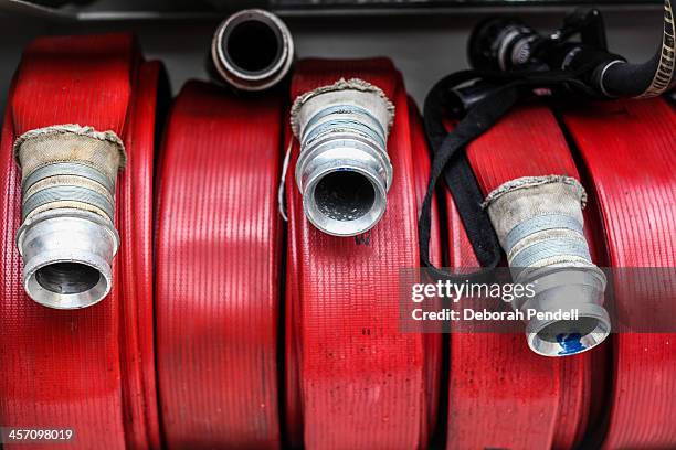 red fire hoses on a fire engine - firetruck stock pictures, royalty-free photos & images