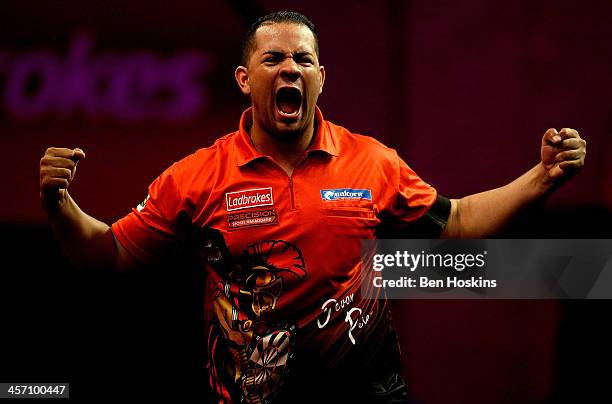 Devon Petersen of South Africa celebrates defeating Steve Beaton of England during his first round match on day four of the 2014 Ladbrokes.com World...