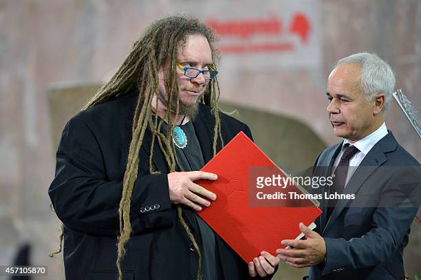 Jaron Lanier is presented with the certificate from Heinrich Riethmueller of the German Book Trade during the award ceremony at Paulskirche on...