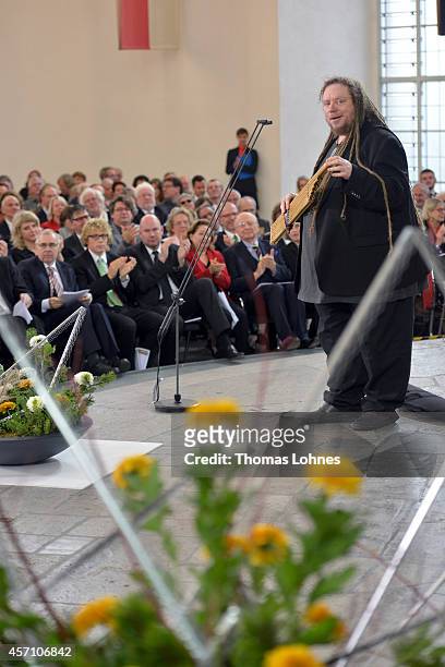 Jaron Lanier speaks to the audience as he plays the instrument of Laos 'Khaen' during the award ceremony at Paulskirche on October 12, 2014 in...