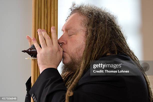 Jaron Lanier plays the instrument of Laos 'Khaen' during the award ceremony at Paulskirche on October 12, 2014 in Frankfurt am Main, Germany....