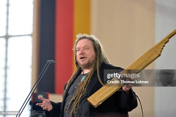 Jaron Lanier speaks to the audience as he plays the instrument of Laos 'Khaen' during the award ceremony at Paulskirche on October 12, 2014 in...