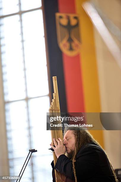 Jaron Lanier plays the instrument of Laos 'Khaen' during the award ceremony at Paulskirche on October 12, 2014 in Frankfurt am Main, Germany....