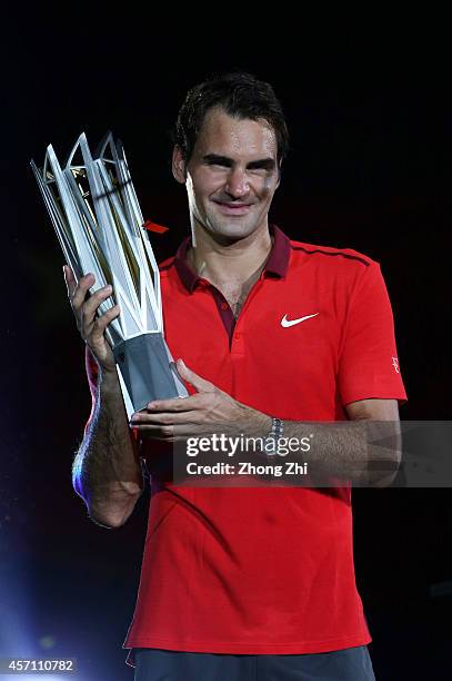 Roger Federer of Switzerland celebrates with the trophy after winning the final match against Gilles Simon of France during the day 8 of the Shanghai...