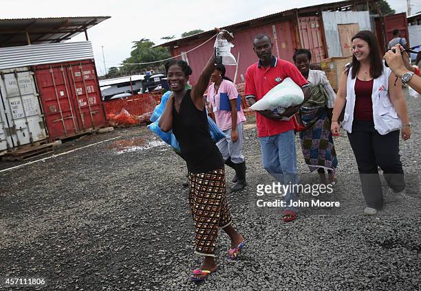 Ebola survivor Sontay Massaley smiles with Doctors Without Borders , staff after being released from the MSF treatment center on October 12, 2014 in...