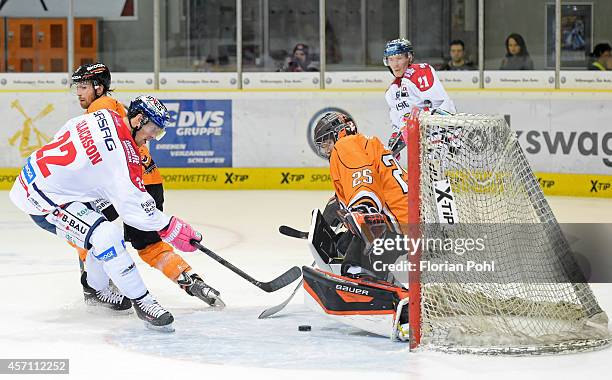 Barry Tallackson of Eisbaeren Berlin scores a goal against Sebastian Vogl of Grizzly Adams Wolfsburg during the DEL match between EHC Wolfsburg and...