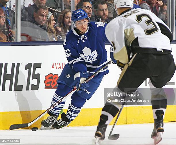 Brandon Kozun of the Toronto Maple Leafs looks to make a play against Olli Maatta of the Pittsburgh Penguins in an NHL game at the Air Canada Centre...