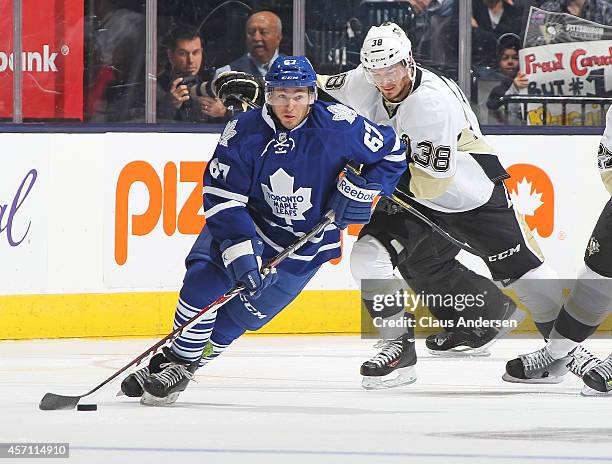 Brandon Kozun of the Toronto Maple Leafs skates with the puck against the Pittsburgh Penguins in an NHL game at the Air Canada Centre on October 11,...