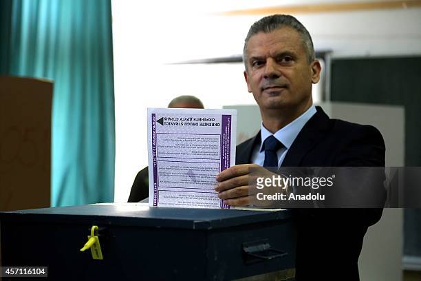 Fahrudin Radoncic, leader of the Union for a Better Future party, and candidate for the next term, casts his vote at a polling station for the...