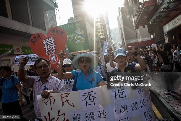 Members of the pro-government Blue Ribbon group march through the streets of Mong Kok to protest the lack of police action against pro-democracy...