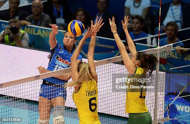 Caterina Bosetti of Italy spikes the ball against to Thaisa Menezes and Sheilla Castro De Paula Blassioli of Brazil during the FIVB Women's World...