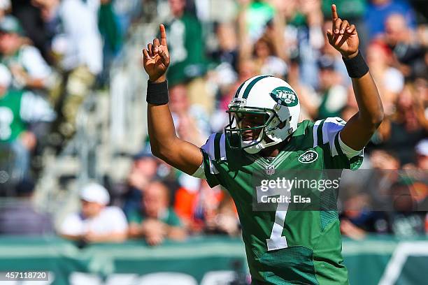 Geno Smith of the New York Jets celebrates after throwing a touchdown pass to teammate Jace Amaro in the first quarter during a game against the...