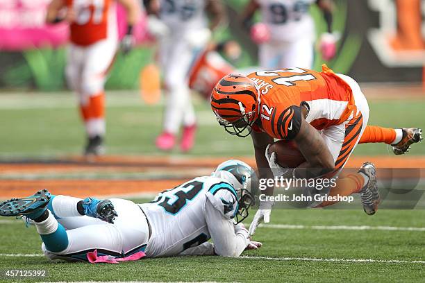 Melvin White of the Carolina Panthers tackles Mohamed Sanu of the Cincinnati Bengals during the third quarter at Paul Brown Stadium on October 12,...