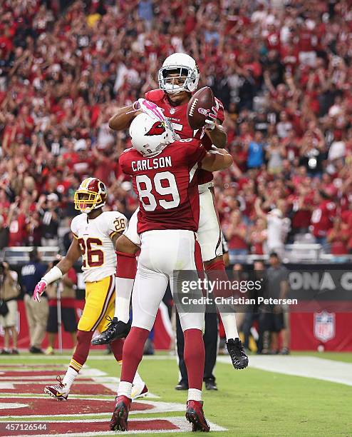 Tight end John Carlson of the Arizona Cardinals celebrates a first quarter touchdown with wide receiver Michael Floyd during the NFL game against the...