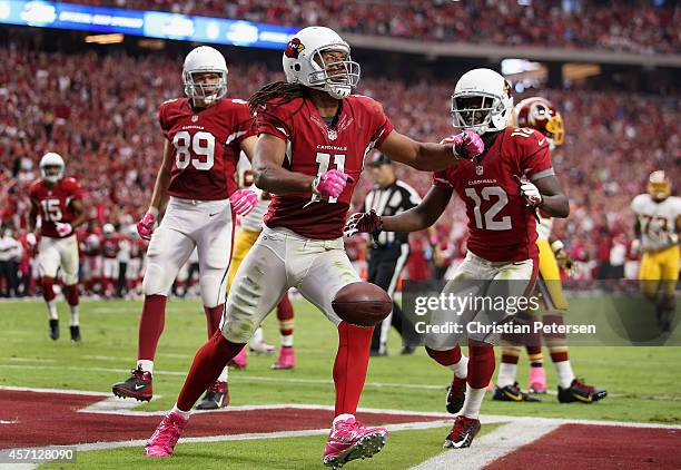 Wide receiver Larry Fitzgerald of the Arizona Cardinals celebrates alongside John Brown after scoring on a 24 yard touchdown reception against the...
