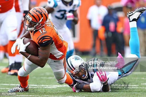 Mohamed Sanu of the Cincinnati Bengals is tackled by Thomas DeCoud of the Carolina Panthers during overtime at Paul Brown Stadium on October 12, 2014...