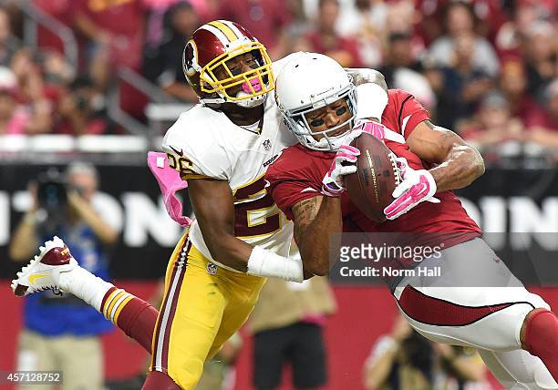 Wide receiver Michael Floyd of the Arizona Cardinals hauls in a first-quarter touchdown pass against corner back Bashaud Breeland of the Washington...