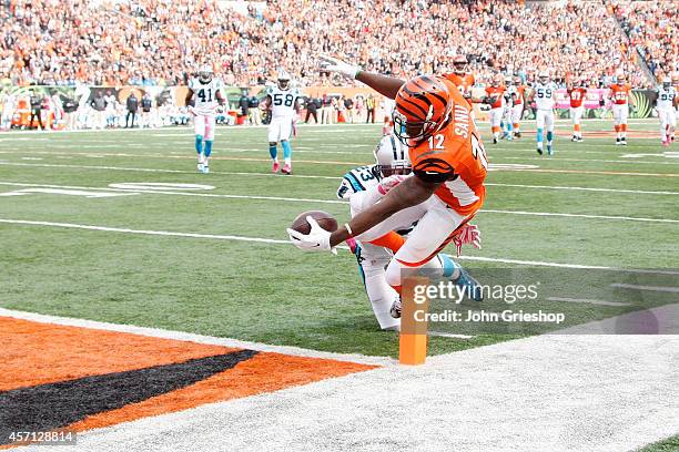 Mohamed Sanu of the Cincinnati Bengals dives to score a touchdown while being hit by Melvin White of the Carolina Panthers during the fourth quarter...