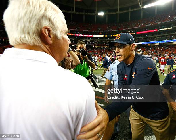 Head coach Marc Trestman of the Chicago Bears shakes hands with head coach Mike Smith of the Atlanta Falcons after their 27-13 win at Georgia Dome on...