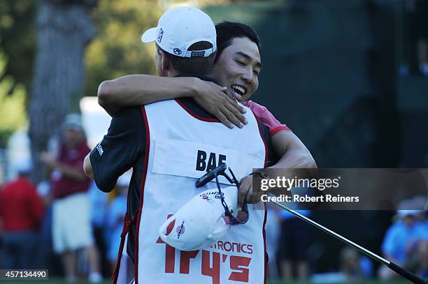 Sang-Moon Bae of South Korea hugs his caddy on the 18th green after winning the Frys.com Open at Silverado Resort and Spa on October 12, 2014 in...